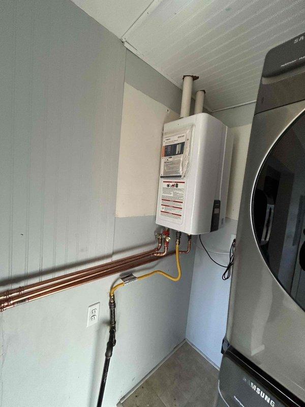 Successfully removed existing 50-gallon tank water heater and installed new wall-mounted tankless unit with proper connections to existing hot and cold water lines. Installed new 2-inch PVC venting through attic with concentric roof flashing, reused existing T&P, and ran condensate line to washer box. Verified proper gas pressure and confirmed system functionality with no leaks before completion.