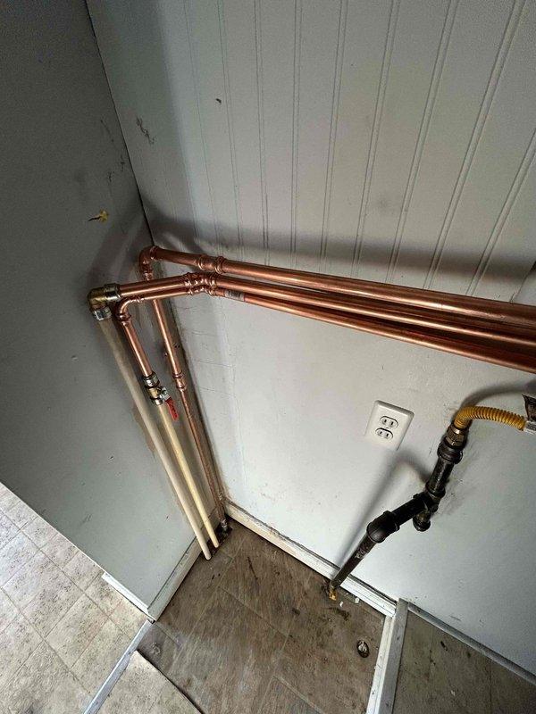 Successfully removed existing 50-gallon tank water heater and installed new wall-mounted tankless unit with proper connections to existing hot and cold water lines. Installed new 2-inch PVC venting through attic with concentric roof flashing, reused existing T&P, and ran condensate line to washer box. Verified proper gas pressure and confirmed system functionality with no leaks before completion.