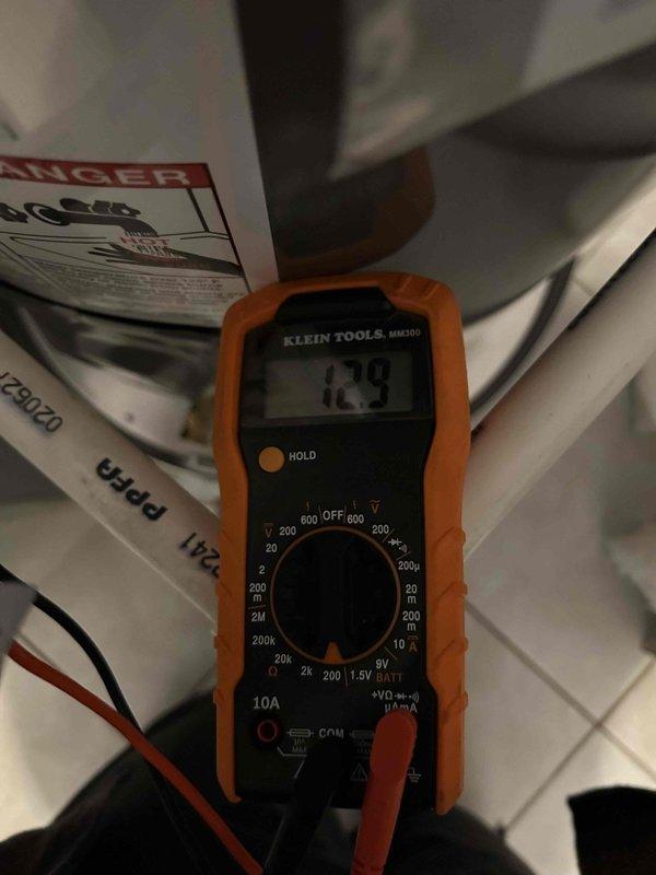 Responded to callback for Unit 201 experiencing hot water issues. Investigation revealed tripped breaker in panel. Performed electrical testing with multimeter and found reading of 12.9V at Rheem Professional water heater. Tightened all electrical connections in the heater's access panel. Restored power and verified proper operation of unit with no further breaker trips.