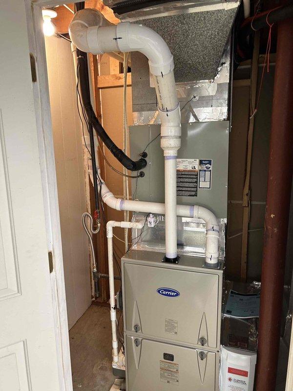 Successfully installed two Carrier 97% efficient gas furnaces: a 100K BTU two-stage unit on the first floor and a 60K BTU two-stage unit on the second floor, with proper venting and drainage systems. Both installations included insulated vent piping, auxiliary drain pans, and were connected to existing thermostats. Investigated and adjusted damper in kitchen ductwork to address uneven temperature distribution issue.