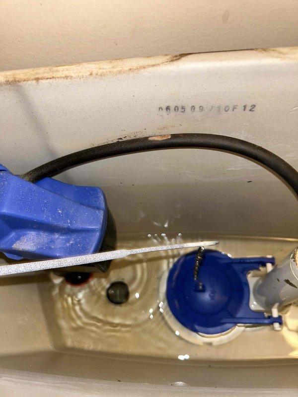 Responded to a water leak service call for an upstairs bathroom toilet. Investigation revealed significant water damage to the ceiling below, with visible staining and saturation. Inspected toilet tank components, finding mineral buildup and wear on the flush valve assembly causing intermittent leakage. Replaced deteriorated flush components and verified proper operation with no further leakage.