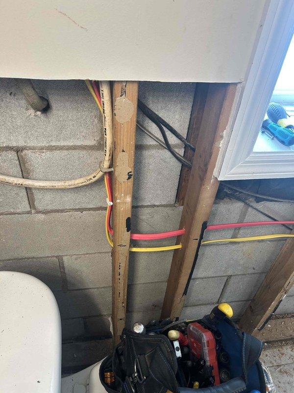 Relocated washer and dryer electrical outlet from one side of the laundry room wall to the other to align with previously moved plumbing. Accessed electrical panel, ran appropriate cabling through wall framing, and installed new outlet at the designated location with proper mounting and connections to ensure safe operation of appliances.
