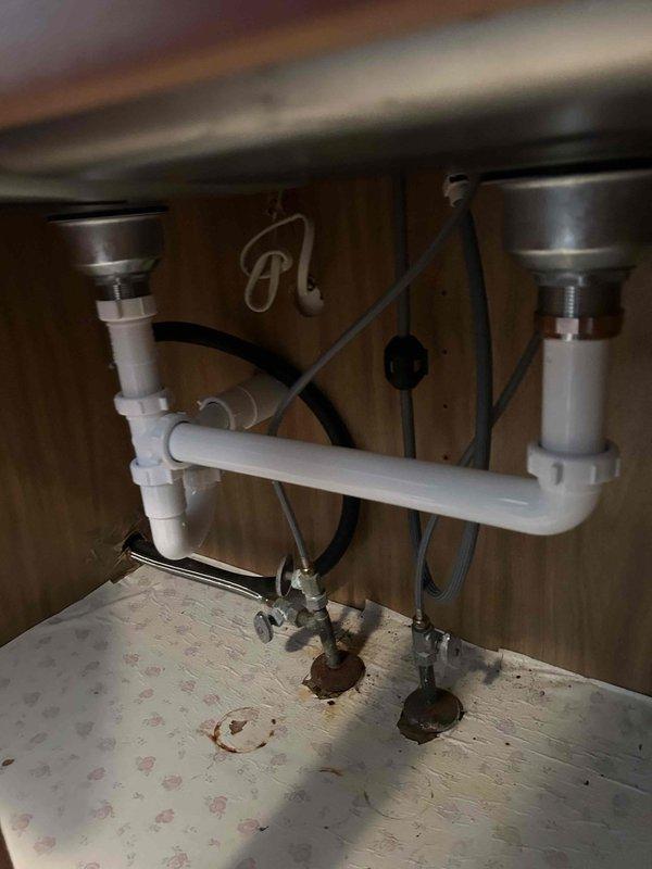 Successfully removed existing kitchen sink setup and installed customer-supplied double-basin stainless steel sink, contemporary faucet with pull-down sprayer, and garbage disposal. Completed proper P-trap configuration with PVC drain pipes for the double basin system and verified leak-free operation and functionality of all components before completion.