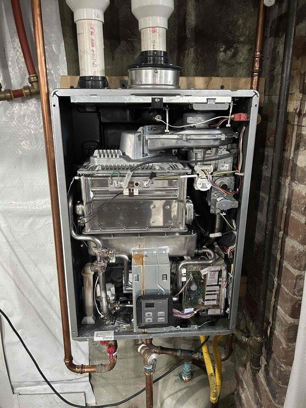 Successfully removed tankless water heater from wall mount, disassembled unit to replace worn gaskets and seals, then reinstalled and tested system. Confirmed proper water flow and temperature at utility sink with no leaks observed throughout the system upon completion.