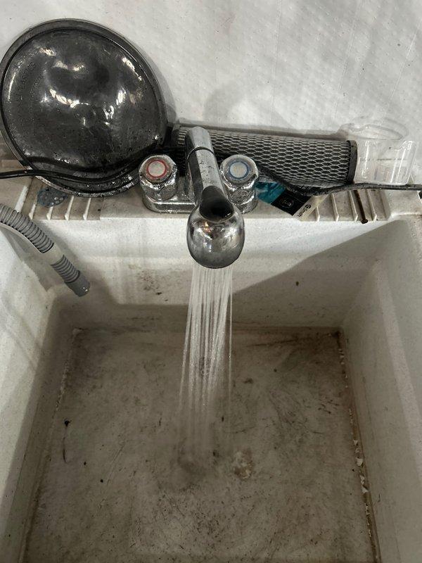 Successfully removed tankless water heater from wall mount, disassembled unit to replace worn gaskets and seals, then reinstalled and tested system. Confirmed proper water flow and temperature at utility sink with no leaks observed throughout the system upon completion.