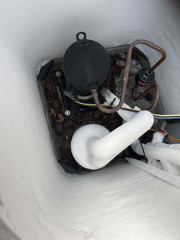 Responded to callback regarding frozen system that was previously serviced in December. Inspection revealed extensive ice accumulation on outdoor unit coils and evaporator. Diagnosed recurring freezing issue caused by malfunctioning condensate pump and restricted drainage. Cleared ice buildup, replaced defective pump, and verified proper system operation before departure.