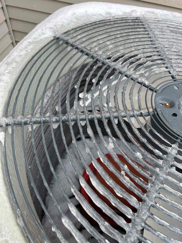 Diagnosed and serviced heat pump exhibiting intermittent metal-on-metal noise during operation. Visual inspection revealed severe frost and ice accumulation on evaporator coils and condenser fan grill, significantly restricting airflow and causing system strain. Performed complete defrost cycle, cleaned coils, and verified proper refrigerant levels to restore normal operation and eliminate noise issue.