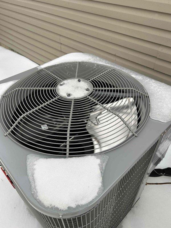Responded to a no-heat service call for a heat pump system. Diagnosed outdoor unit covered with significant ice and snow buildup, preventing proper operation and causing loud noise during operation. Cleared ice accumulation from coil and fan assembly, restored proper airflow, and verified normal system function after defrost cycle completed.