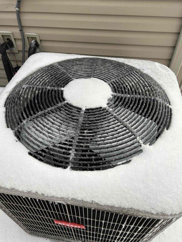 Responded to a no-heat service call for a heat pump system. Diagnosed outdoor unit covered with significant ice and snow buildup, preventing proper operation and causing loud noise during operation. Cleared ice accumulation from coil and fan assembly, restored proper airflow, and verified normal system function after defrost cycle completed.