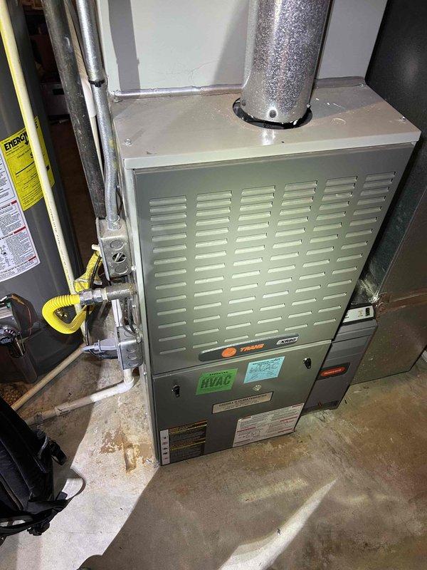 Responded to no heat complaint for a Trane gas furnace system less than 10 years old. Upon arrival, found system blower not operating despite thermostat set to 70°F with house temperature at 62°F. Conducted diagnostic testing which revealed a faulty control board causing blower malfunction. Replaced control board, verified proper operation with temperature readings showing 72°F at supply duct. System now functioning normally with appropriate heat output.
