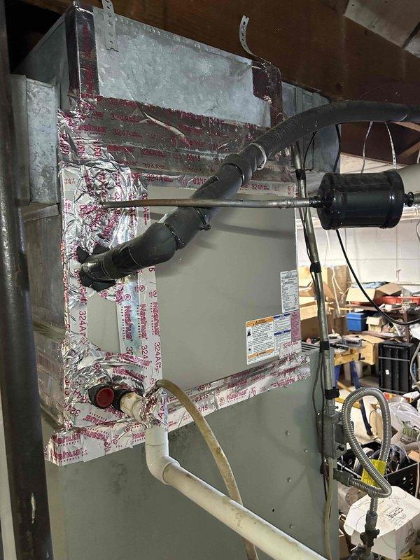 Responded to non-urgent service call for a 30-year-old furnace producing loud squealing noise. Upon inspection, removed access panel to examine internal components, focusing on the blower motor assembly which was identified as the source of noise. System was still operational but showing significant age-related wear on mechanical components.