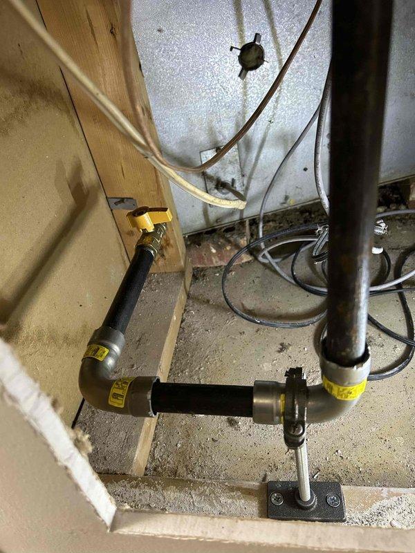 Installed new gas line to customer's fireplace, running black pipe with appropriate fittings from the existing gas supply. Secured pipe with metal mounting brackets and applied proper labeling at connection points to ensure safety compliance.