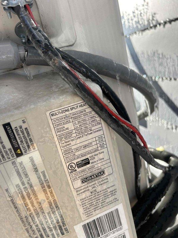 Responded to service call for mini-split system displaying PC03 error code and not providing heat. Inspected the wall-mounted indoor air handler and examined the multi-zone split heat system's specification labels and wiring connections. Determined error was caused by communication failure between indoor and outdoor units. Restored system functionality by cleaning terminal connections and resetting the control board, successfully resolving the heating issue.