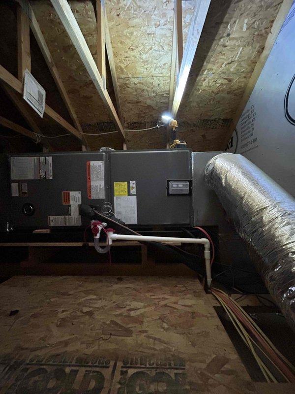 Successfully installed a complete RUUD Heat Pump System including a 3.5-ton outdoor heat pump unit (RP14AY42AJ2NA), attic-mounted air handler (RH2TY4821STANNJ), 15KW heat kit (RXBH-1724A15J-B), and digital thermostat. System installation included all necessary components: outdoor pad with snow legs, electrical connections with disconnect box and whip kit, refrigerant line insulation and filter, condensate trap with SS2 coil drain safety water sensor, overflow drain pan with "Ceiling Saver" water sensor, and transition to existing ductwork.
