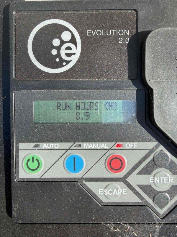 Performed maintenance inspection on Generac air-cooled generator (Model G00722510, SN 3015641735). Identified yellow warning light indicating battery check required. Verified system functionality through Evolution 2.0 control panel with current run hours at 8.9. Documented unit specifications and Wi-Fi connectivity information for future reference.