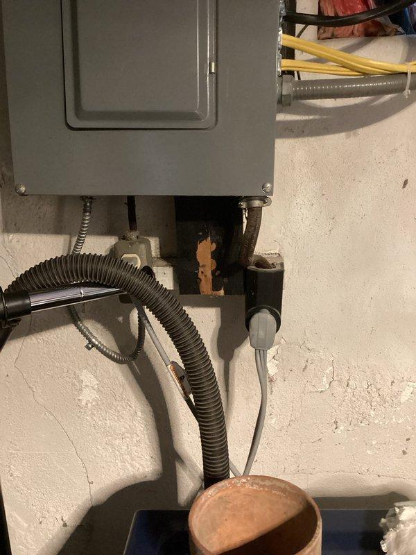 Conducted comprehensive assessment of existing electrical panel for generator installation compatibility. Documented panel condition, noting visible wall damage around mounting area and inspecting all connected conduits and wiring. Evaluated available connection points and load capacity to determine appropriate generator integration requirements.