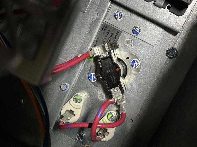 Responded to no heat call for electric heat pump system less than 10 years old. Upon inspection of the air handler in the crawl space, identified faulty thermal limit switch with improper electrical connections. Replaced thermal switch component and verified proper wiring to terminal connections. System tested and confirmed proper heat operation before completing service.
