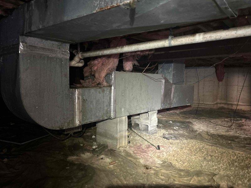 Responded to no-heat service call for 38-year-old electric HVAC system. Upon inspection, discovered significant frost accumulation on outdoor unit and deteriorating ductwork insulation in crawlspace. Performed defrost cycle and replaced aging components to restore heating functionality.