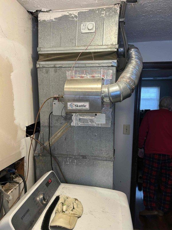 Conducted site visit to provide quote for Aprilaire 620A whole-home humidifier installation on recently installed Carrier heat pump/air handler system located in basement. Inspected existing HVAC setup including Skuttle component and associated ductwork to determine compatibility and optimal mounting location for requested humidifier. Photos taken of installation area for reference during quote preparation.