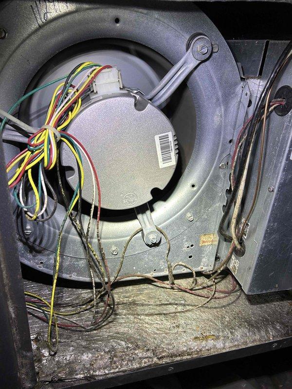 Performed diagnostic assessment on 11-year-old Climate Master geothermal system after customer reported no heat and previous board replacement by another company. Inspection revealed worn blower motor with significant dust accumulation and deteriorated capacitor connections. Recommended system replacement due to age and multiple component failures rather than continuing costly individual repairs.
