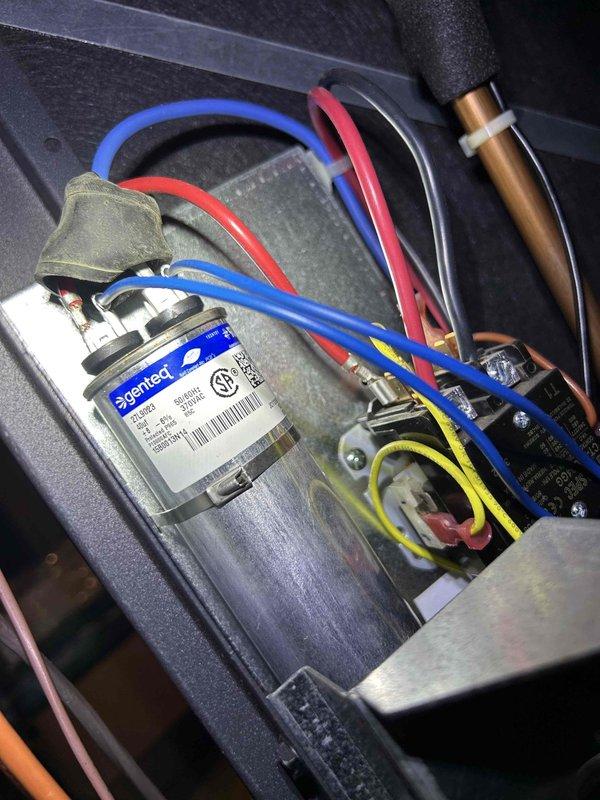 Performed diagnostic assessment on 11-year-old Climate Master geothermal system after customer reported no heat and previous board replacement by another company. Inspection revealed worn blower motor with significant dust accumulation and deteriorated capacitor connections. Recommended system replacement due to age and multiple component failures rather than continuing costly individual repairs.