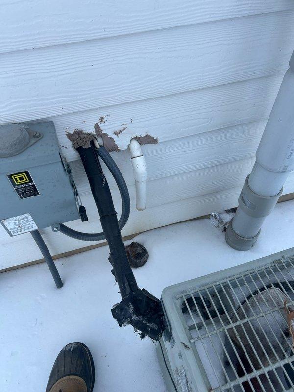 Responded to no-heat call for 1-year-old propane gas system. Inspection revealed damaged electrical conduit at exterior junction box with exposed wiring, compromising system operation. Additionally noted plumbing issues in utility area with exposed PVC piping and incomplete insulation. Repaired damaged conduit and restored power to unit, returning heating functionality to the vacant property.