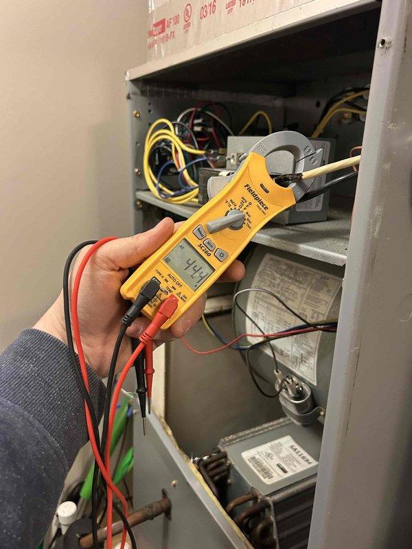 Responded to non-urgent service call for HVAC system making loud noise with unusual odor. Performed electrical diagnostics using multimeter, confirming voltage readings of 144V at the control panel. Inspected and tested thermostat functionality, which was operating correctly at set point of 69°F. Identified and resolved issue with system components causing the noise and odor.