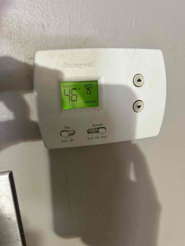 Responded to service call back for no heat issue after initial repair. Found system not heating despite thermostat showing "Heat On" with indoor temperature of 46°F (set point 75°F). Diagnosed and replaced failed capacitor, reconnecting all electrical terminals properly. System now functioning correctly with verified heat output.