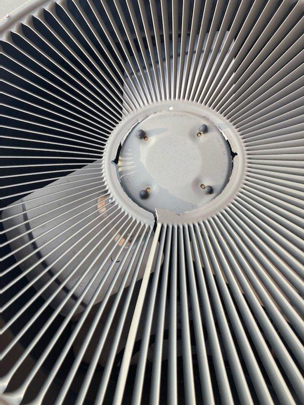 Responded to service call for a 2-year-old heat pump system with no heat. Upon inspection, found the outdoor unit had shifted 4-6 inches off its pad with significant physical damage. Visual assessment confirmed condenser fan assembly damage. System was non-operational due to displacement likely caused by external forces, with snow accumulation around the unit complicating the situation.