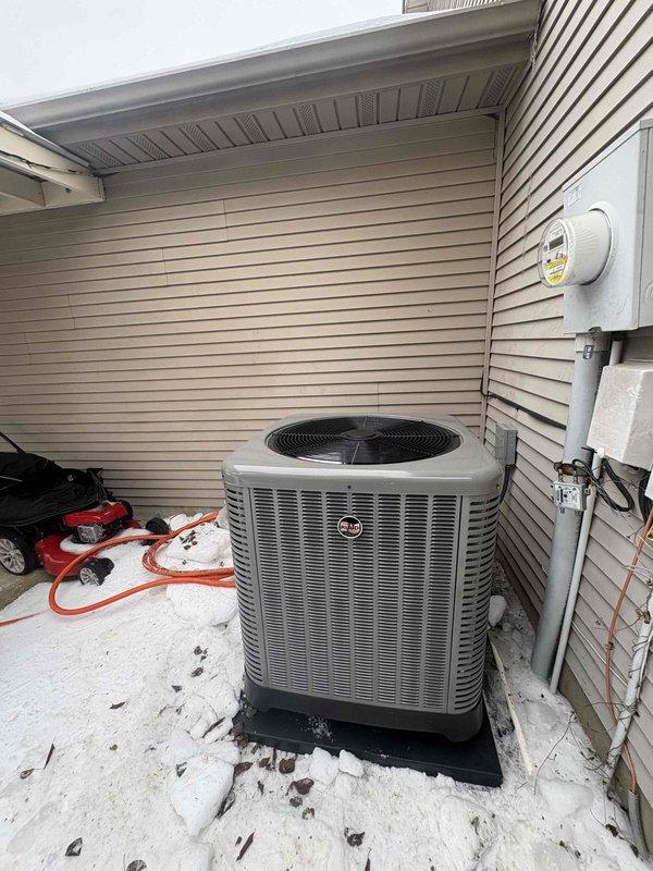 Completed installation of a RUUD 2.5 ton 14.3 SEER2 Two Stage Heat Pump system with matching RUUD Air Handler (attic-mounted) and 15KW Heat Kit. System was properly mounted with standard accessories including outdoor pad, snow legs, electrical connections, refrigerant line components, condensate management features, and connected to existing thermostat and ductwork.