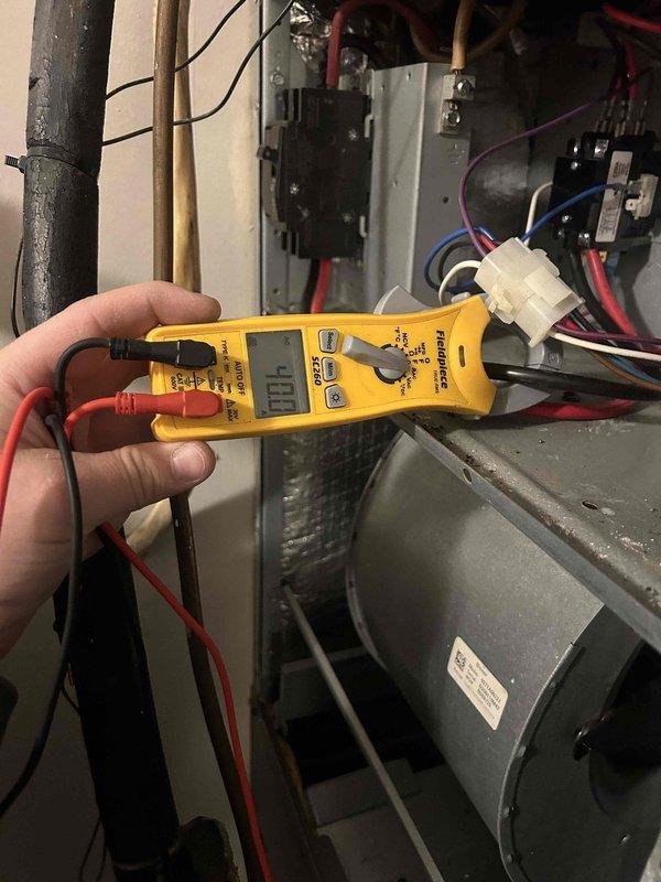 Responded to no heat complaint on 7-8 year old electric InterTech system. Diagnostic testing with multimeter revealed no voltage at control board where customer reported burnt red wire. Inspected electrical connections, identified and replaced damaged control board wiring harness to restore proper connection to thermostat. System functioning normally after repair with heat cycle confirmed.
