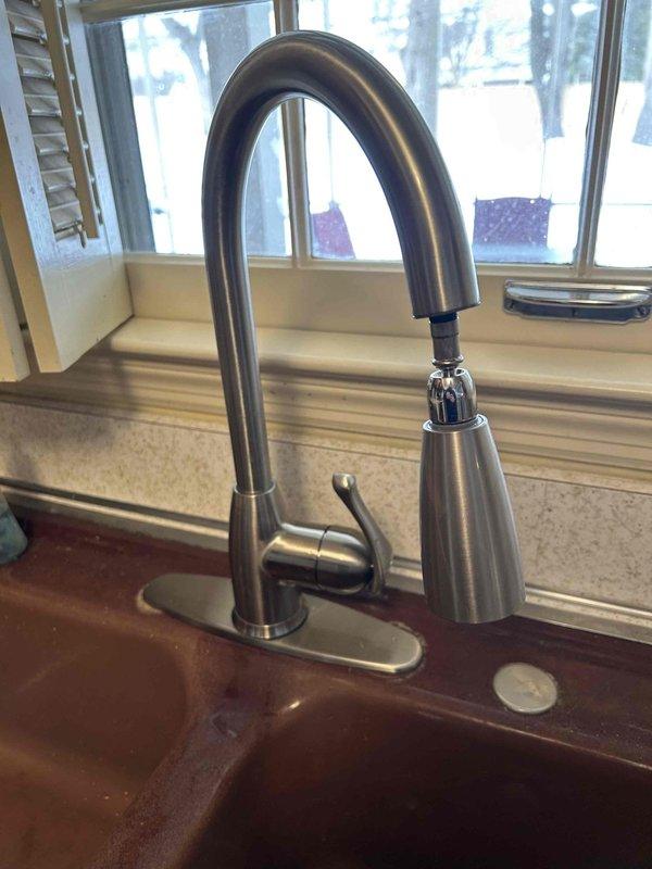 Responded to service call for bathroom faucet with persistent drip. Removed old fixture and replaced with new modern stainless steel faucet featuring high-arch design and pull-down spray head. Confirmed proper installation with no leaks in the P-trap assembly and supply lines.