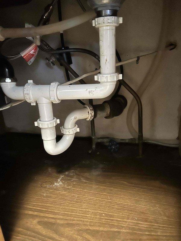 Responded to service call for bathroom faucet with persistent drip. Removed old fixture and replaced with new modern stainless steel faucet featuring high-arch design and pull-down spray head. Confirmed proper installation with no leaks in the P-trap assembly and supply lines.