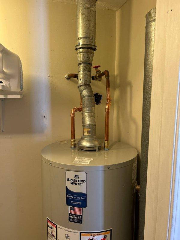 Successfully installed a new 40-gallon Bradford White gas water heater in customer's utility area. Completed full installation including proper venting with galvanized steel pipe and connection of copper supply lines with appropriate valving. Verified proper ignition and combustion after installation, confirming unit is operating according to manufacturer specifications.