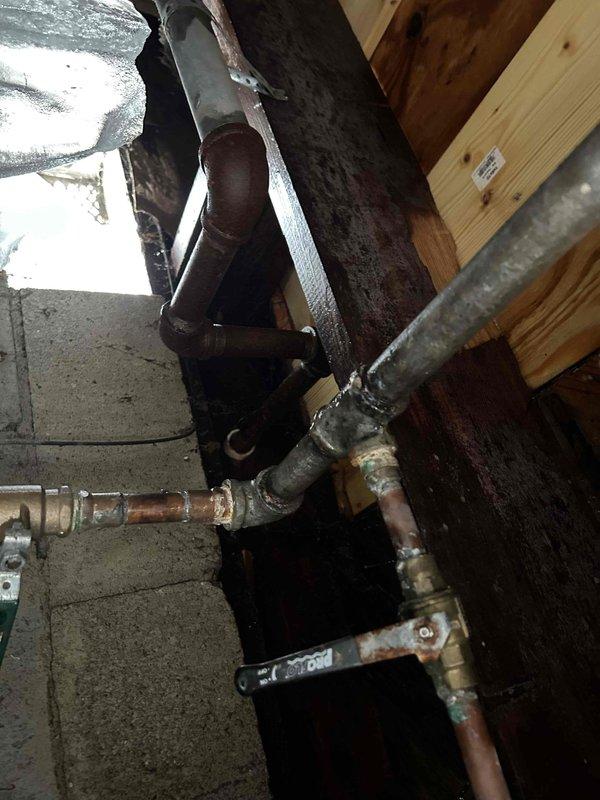 Responded to a callback regarding a water leak in the crawl space. Upon inspection, found damaged wooden joists with significant deterioration and splits near the plumbing infrastructure. Located the source of the leak at a corroded copper pipe joint. Repaired the compromised section by replacing with new PEX piping and brass fittings. Additionally, installed insulation around pipes at the crawl space entrance as requested. Verified system integrity with pressure test after repair. Water was shut off at street valve upon completion per customer instructions.