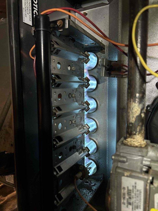 Performed routine Care Plan maintenance on 15-year-old heat pump/gas furnace system located in crawl space. Inspected condensate pump installation and verified proper drainage configuration. Checked gas burner assembly operation, confirming clean blue flame pattern across all six burners indicating proper combustion. Customer supplied filters as per agreement.