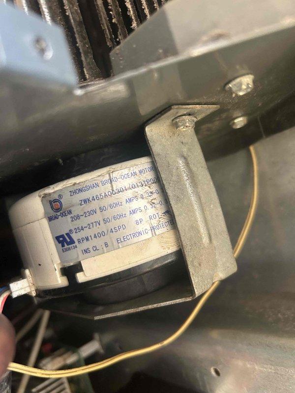 Responded to no heat complaint at Fairfield Inn for three PTAC units in hotel rooms. Upon inspection, discovered significant corrosion and mineral buildup on critical components including heat exchanger and piping. Located Zhongshan Broad-Ocean Motor (model ZWK465A052G01/01900) with electronic protection, which was functioning but compromised by extensive aging and oxidation of surrounding components. Cleaned accessible parts and restored heating function to all three units, but recommended scheduling replacement of aging components due to visible deterioration that may lead to future failure.