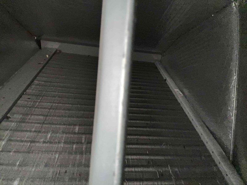 Performed Care Plan Tune Up on heat pump/air handler system with Platinum UV light installed in attic. Inspected evaporator coils showing minor dust accumulation and examined ductwork with reflective insulation. System has adequate clearance despite confined installation space. Customer provides their own filters.