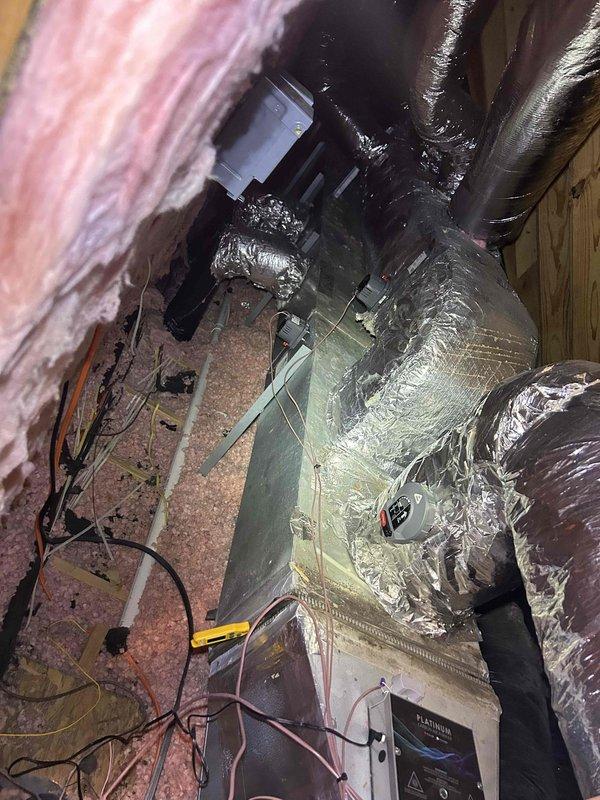 Performed Care Plan Tune Up on heat pump/air handler system with Platinum UV light installed in attic. Inspected evaporator coils showing minor dust accumulation and examined ductwork with reflective insulation. System has adequate clearance despite confined installation space. Customer provides their own filters.