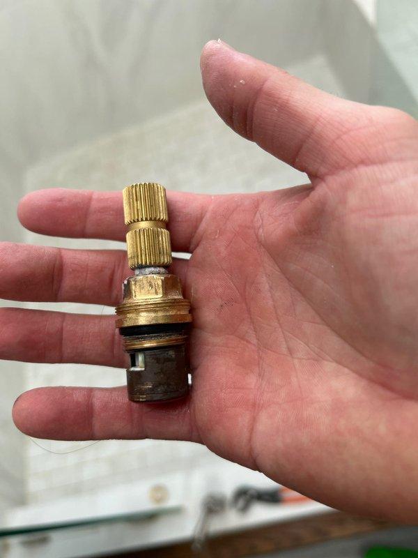 Responded to service request for leaking shower head. Upon inspection, removed and replaced worn valve stem assembly with new component, which included replacing deteriorated O-ring/washer that was causing the leak. Tested fixture after repair and confirmed proper operation with no leaks.