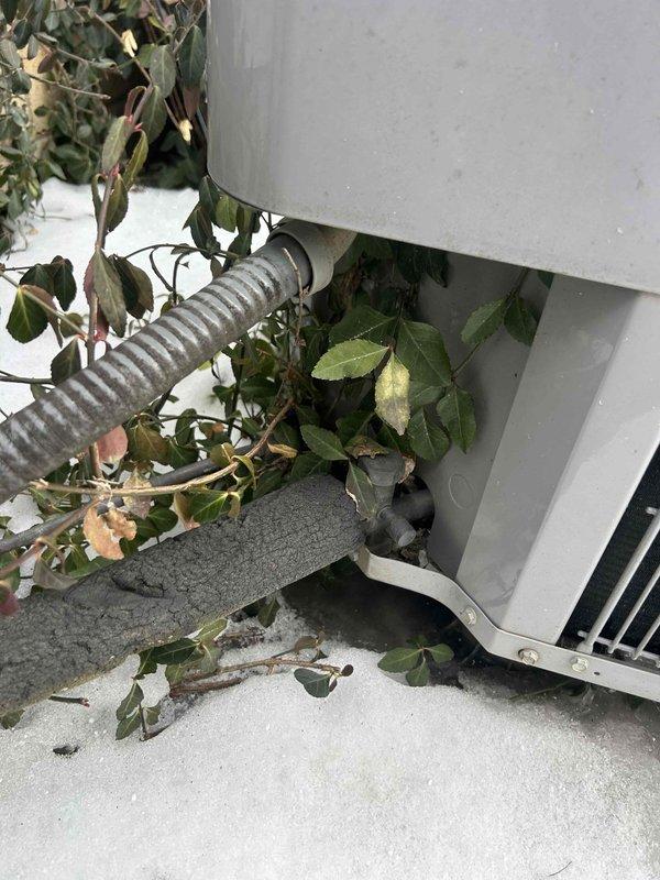Performed scheduled Care Plan Tune Up on heat pump/air handler system located in garage. Inspected outdoor unit which showed vegetation encroachment that could potentially restrict airflow. Verified thermostat operation with system maintaining 69°F setpoint. Customer supplies their own filters, which were previously washable type.