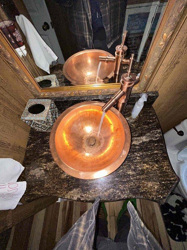 Completed routine plumbing inspection as requested. Examined copper bathroom sink and fixtures, confirming proper installation and function. Tested kitchen sink water flow, observing normal drainage with no evident leaks or blockages in either location.