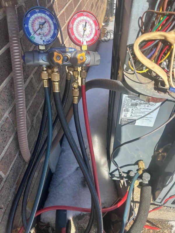 Responded to no-heat call for 9-year-old electric HVAC system located in customer's crawl space. Diagnostic testing revealed refrigerant pressure imbalance, which was confirmed using manifold gauge set connected to service ports. System was recharged to manufacturer specifications, restoring proper heating function.