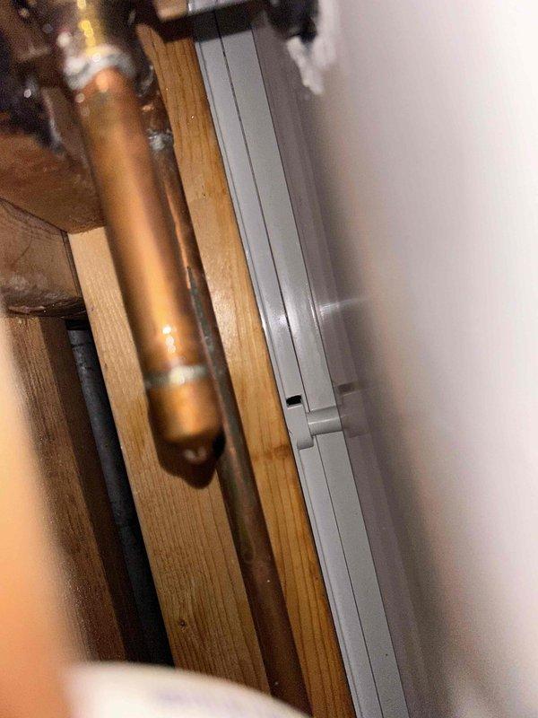 Diagnosed and repaired continuously running shower by accessing plumbing through wall opening. Inspected copper supply lines and drain assembly, identifying faulty valve components as the source of the leak. Replaced worn cartridge and seals to restore proper water flow control.