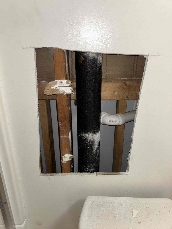 Diagnosed and repaired continuously running shower by accessing plumbing through wall opening. Inspected copper supply lines and drain assembly, identifying faulty valve components as the source of the leak. Replaced worn cartridge and seals to restore proper water flow control.