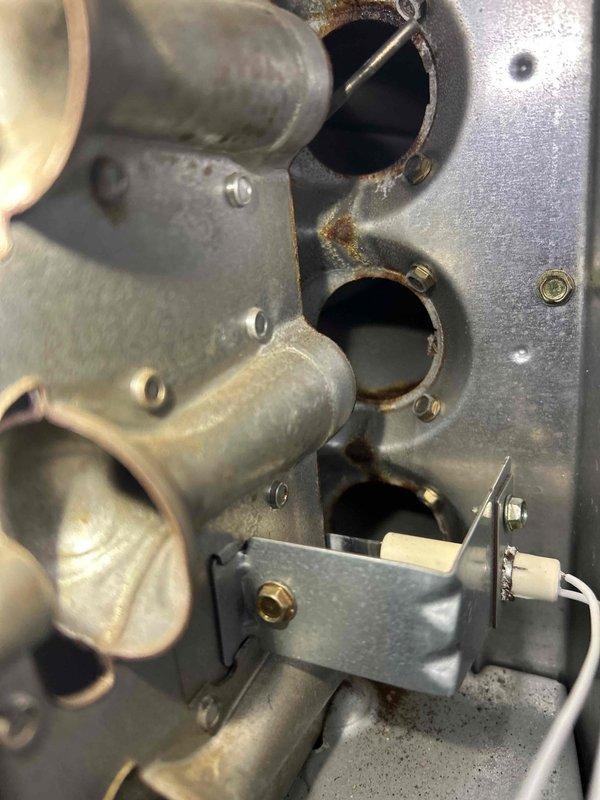 Responded to no heat complaint on property being prepared for sale. Inspection revealed a rusted heat exchanger with significant corrosion around ports, compromising system safety. Outdoor condenser unit was operational but surrounded by snow accumulation. Replaced faulty heat exchanger and cleared snow from around outdoor unit to restore proper system function and ensure safe operation.