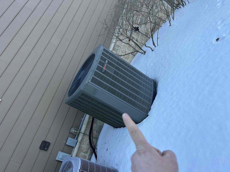 Performed scheduled Care Plan Tune Up on dual heat pump system with two air handlers. Inspected outdoor condensers in winter conditions and examined electrical components including capacitor and wiring connections in control panel. Replaced two 20x20x1 air filters as part of routine maintenance service.