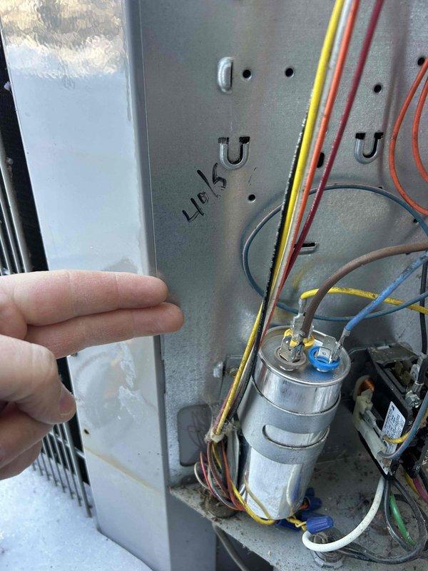 Performed scheduled Care Plan Tune Up on dual heat pump system with two air handlers. Inspected outdoor condensers in winter conditions and examined electrical components including capacitor and wiring connections in control panel. Replaced two 20x20x1 air filters as part of routine maintenance service.