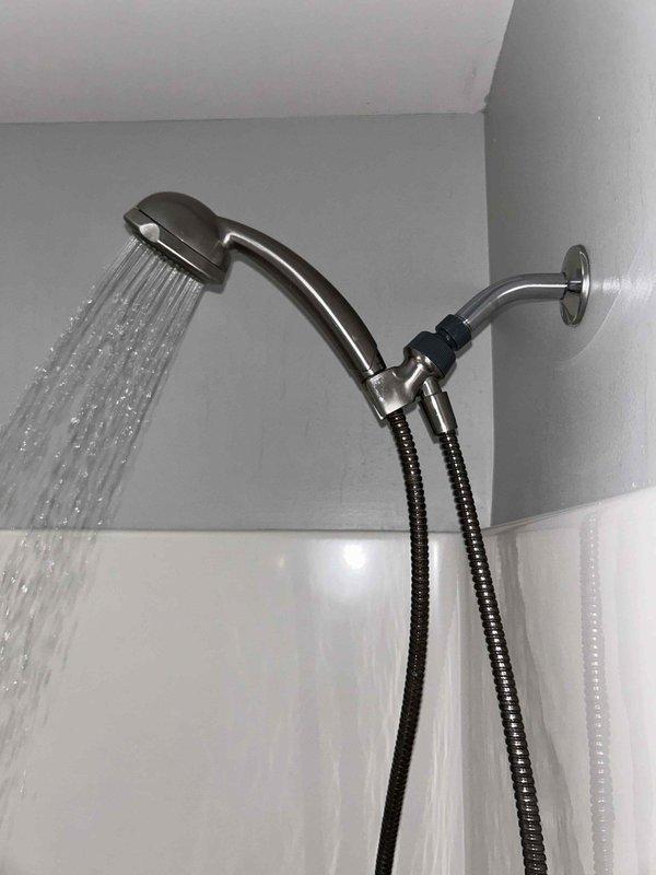 Conducted routine plumbing inspection of bathroom fixtures. Verified proper toilet flushing operation and water flow. Tested shower head functionality, confirming adequate water pressure and distribution through all nozzles with no visible leaks in the fixture or connecting hose.