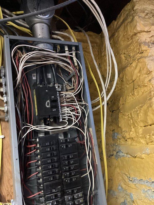 Conducted electrical estimate for potential Kohler generator installation. Inspected existing electrical panel system, which includes main circuit breaker panel and adjacent junction box mounted on masonry wall. Documented current panel configuration, wire routing, and available capacity to determine requirements for generator integration.
